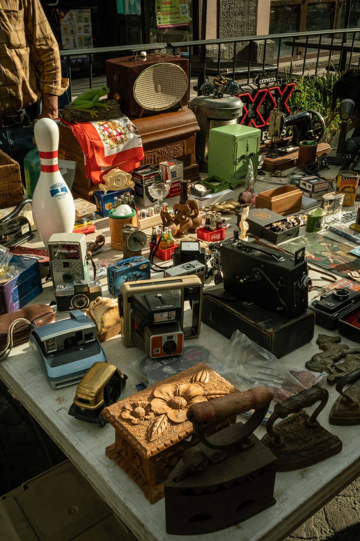 Secondhand radios, cameras, and other found objects on a flea-market stall in Aguascalientes, Mexico